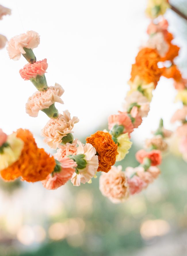 an arrangement of flowers hanging from the ceiling