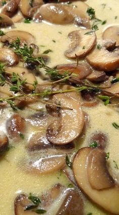 a pan filled with mushroom soup and garnished with parsley