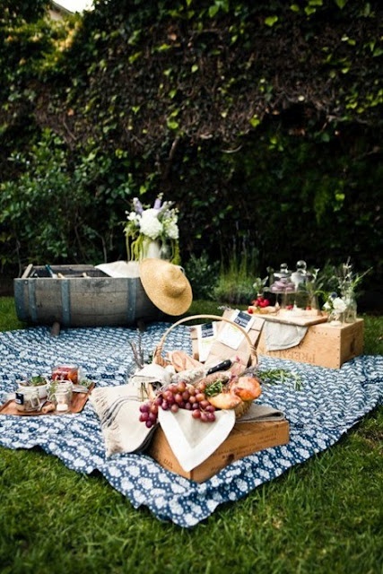 an outdoor picnic is set up on the grass