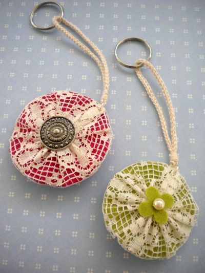 two pieces of fabric are hanging from hooks on a blue surface with white and red squares