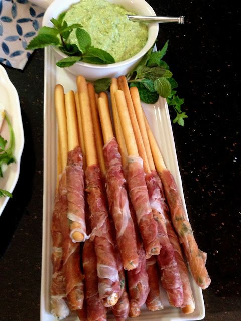 there are many different types of meats on the plate and in bowls next to each other