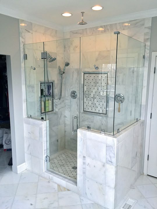 a walk in shower sitting inside of a bathroom