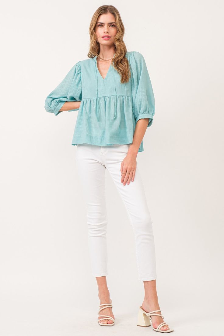 image of a female model wearing a MALIA V-NECK TOP BIO MINT DEAR JOHN DENIM Chic V-neck Top In Relaxed Fit For Spring, Casual Cotton V-neck Blouse, Cotton V-neck Blouse For Casual Gatherings, Spring Cotton Peasant Top For Brunch, Spring Relaxed Fit Long Sleeve V-neck Top, Chic Relaxed Fit V-neck Top For Spring, Chic V-neck Peasant Top Relaxed Fit, Chic Relaxed Fit V-neck Peasant Top, Spring Split Neck Blouse For Brunch