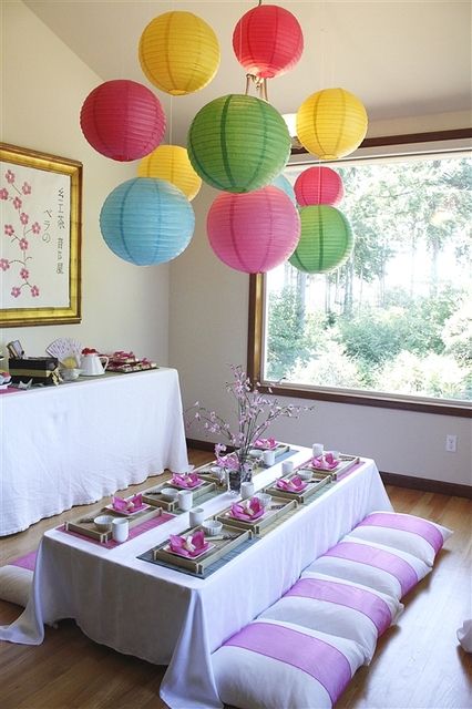 the table is set up with paper lanterns