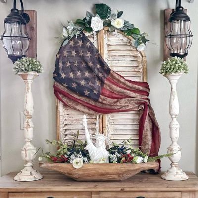 an american flag hanging on the wall above a dresser