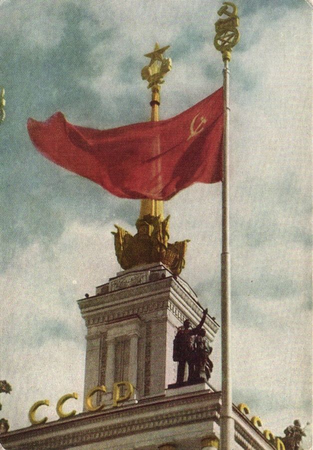 an image of a red flag on top of a building with gold trimmings