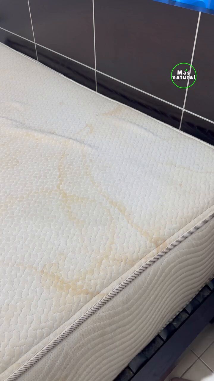 a mattress that has been washed and is sitting on the floor in front of a tiled wall