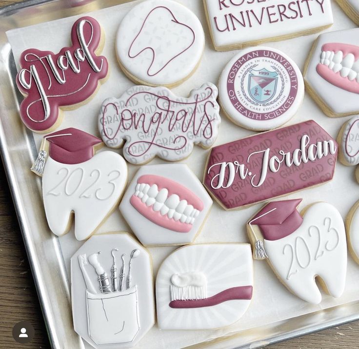 decorated cookies are arranged in the shape of toothbrushes and dental instruments on a tray