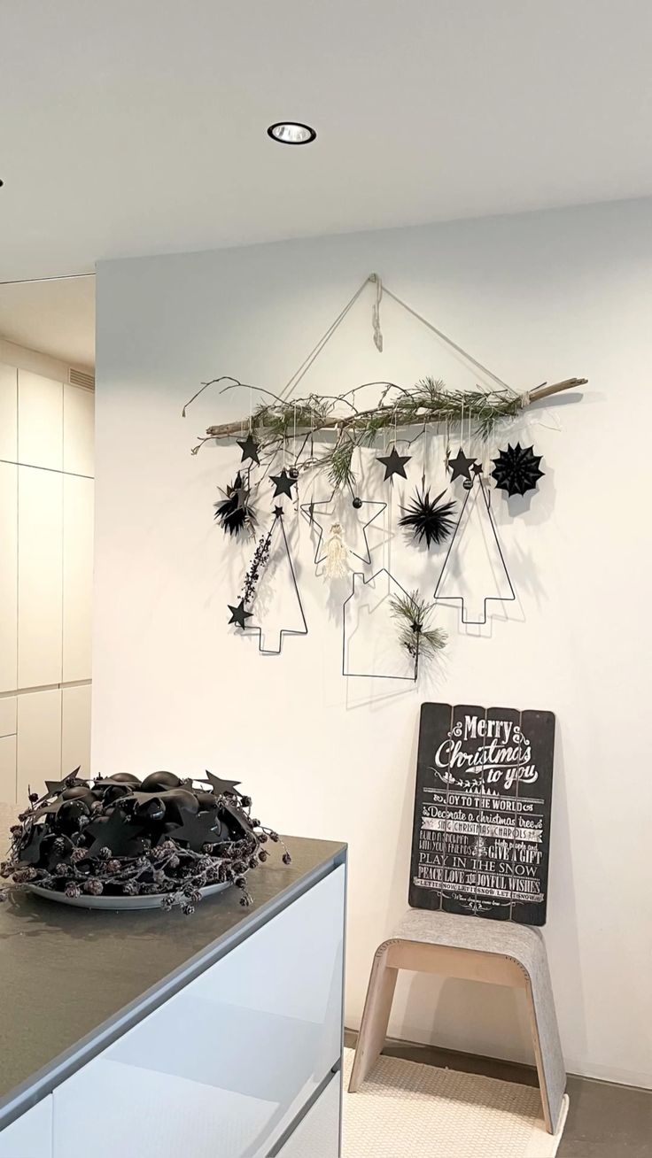 a kitchen counter with a black and white sign hanging from the wall next to it