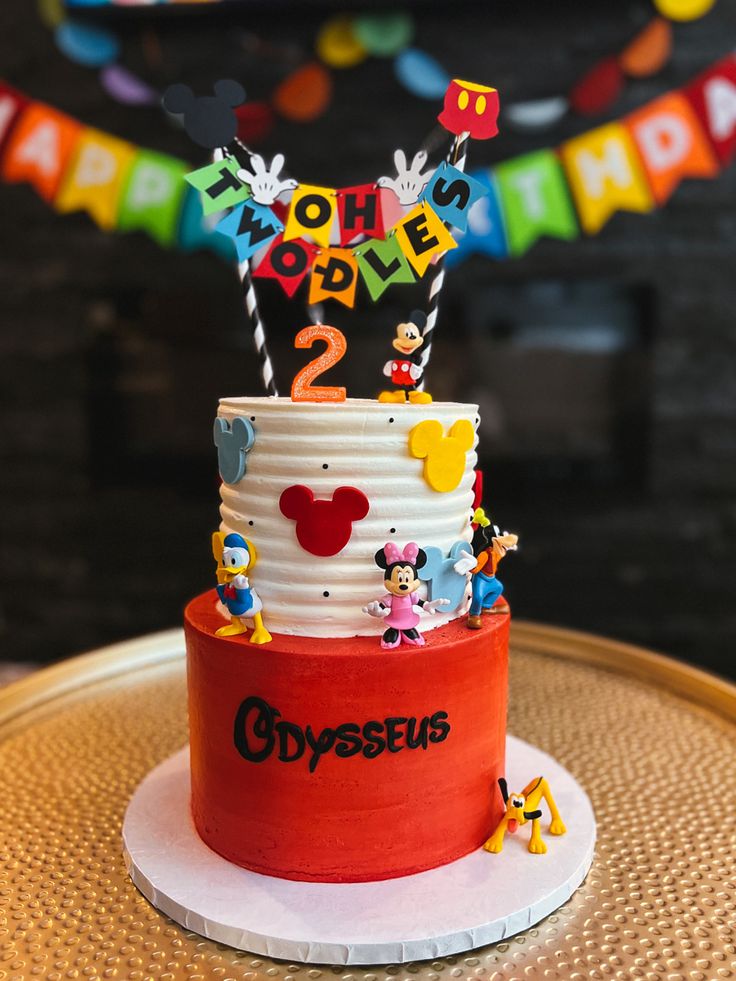 a mickey mouse birthday cake on a table