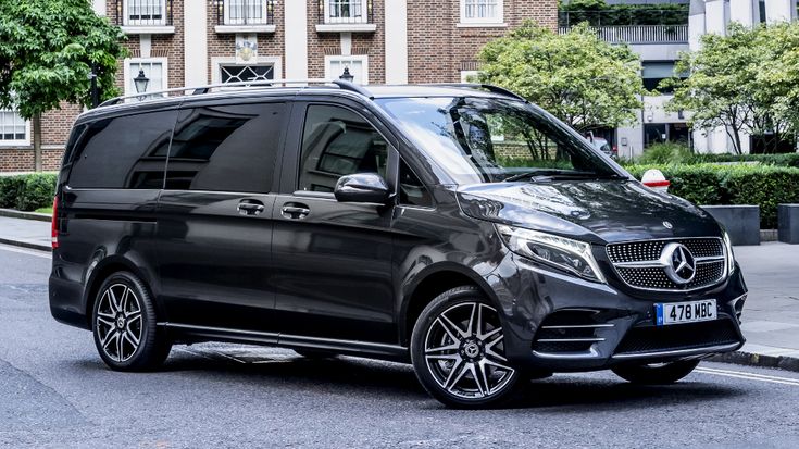 a black mercedes benz van parked on the street