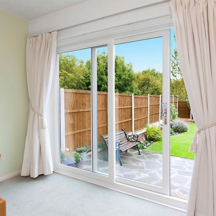 an empty room with sliding glass doors leading outside