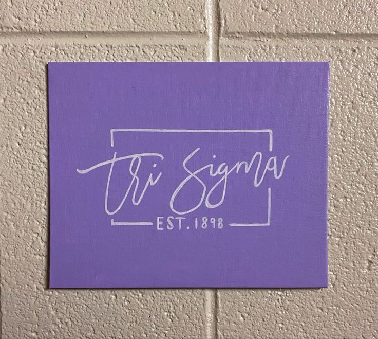 a purple sign that says tri signal est1989 on the side of a brick wall