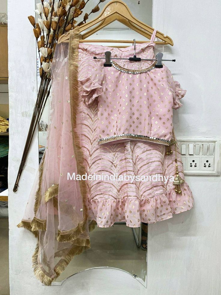 Product: Custom stitched girl kids children dress. Baby girls pink party dresses for special occasions the dress can be converted to dressing gowns or anarkali too Dress best suits for baby girl 1st birthday We stitch this lehenga for 15 year old 13 year old, 12 year old or any further teens size Lehnga come with chunni and waist is tie belt tassels and latkan Fabric: Lehenga- soft silk with gota sequins work embroidery all over Top -georgette with gold print frill sleeves embellished with mirro Bollywood Style Ruffled Dresses For Navratri, Bollywood Festive Dresses With Ruffles, Festive Bollywood Dresses With Ruffles, Diwali Anarkali Traditional Wear With Ruffles, Diwali Anarkali With Ruffles, Bollywood Style Ruffled Anarkali Set For Diwali, Pink Ruffled Choli For Navratri, Anarkali Choli With Ruffles For Festivals, Festive Anarkali Traditional Wear With Ruffles