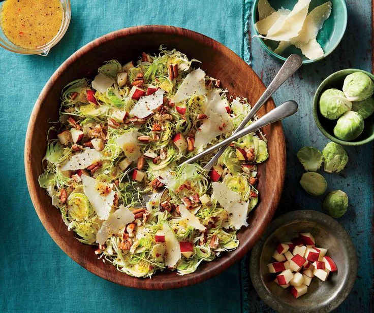 a wooden bowl filled with shaved brussels sprouts