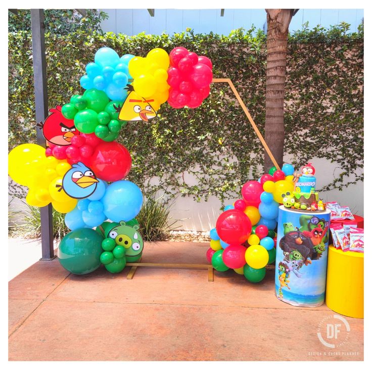 the balloon arch is decorated with angry birds and other colorful balloons for a birthday party