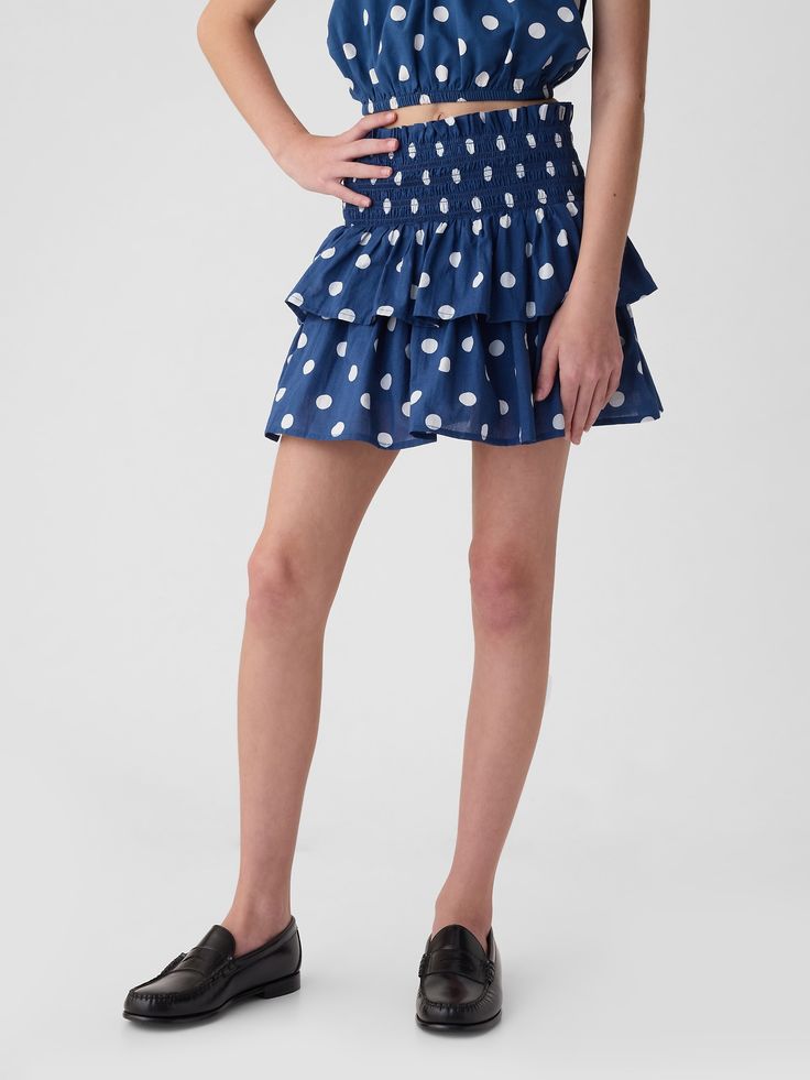 Soft cotton skort.  Smocked waist.  Tiered ruffle skirt.  Inner shorts.  Easy pull-on waist.  Easy through the hip and thigh. Spring Skirted Bottoms With Gathered Waist, Blue Bottoms With Gathered Waist For Summer, Blue Gathered Waist Bottoms For Summer, Tiered Skirt With Gathered Waist For Vacation, Summer Skirted Bottoms With Smocked Back, Polka Dot Bottoms For Vacation In Spring, Polka Dot Skirted Bottoms For Summer, Polka Dot Skirted Bottoms For Spring, Summer Polka Dot Skirted Bottoms