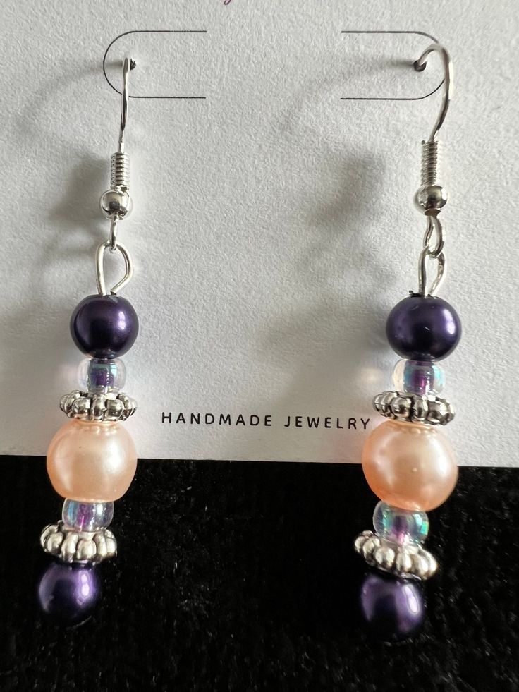 These beautiful lightweight glass and metal bead earrings are sure to add a beautiful accent to any wardrobe!  They offer just the right elegance to any outfit.   The color combination is magnificent with deep purple and pink beads combined with the silver accents. All jewelry is nickel free.   All of my earrings are made with nickel-free, hypoallergenic ear wires.  The earring backs are made of clear silicone.  The hooks themselves are silver plated. Earrings are approximately 1 1/2" in length Elegant Purple Beaded Earrings With Colorful Beads, Elegant Lavender Beaded Earrings With Dangling Beads, Elegant Lavender Beaded Drop Earrings, Elegant Lavender Beaded Earrings, Elegant Multicolor Nickel-free Beaded Earrings, Elegant Purple Crystal Earrings With Dangling Beads, Elegant Crystal Earrings With Colorful Round Beads, Elegant Silver Earrings With Colorful Beads, Elegant Pink Czech Glass Earrings