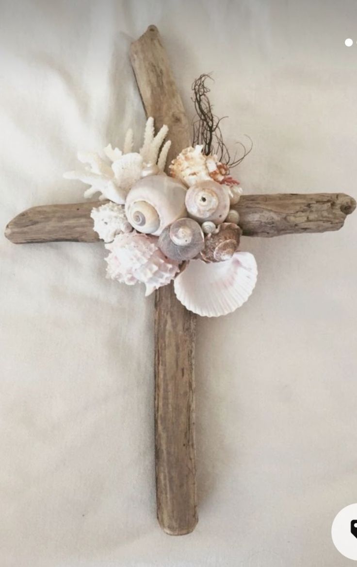 a cross with shells and seashells on it