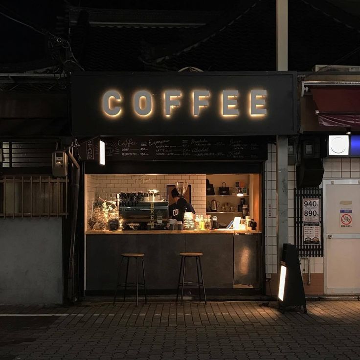 the coffee shop is lit up at night