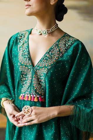 Green short kaftan with sequin thread embroidered floral paisley motifs on polka dot print base and fringe tassels. Comes with inner slip and cowl pant. - Aza Fashions Festive Blouse With Pallu For Rituals, Navratri Rituals Pallu Blouse, Bohemian Kurta With Gota Work For Navratri, Bohemian Kurta With Gota Work, Bohemian Gota Work Kurta For Navratri, Festive Motif Kaftan For Festivals, Festive Motifs Kaftan For Festivals, Festive Bohemian Blouse With Cutdana, Festive Bohemian Cutdana Blouse