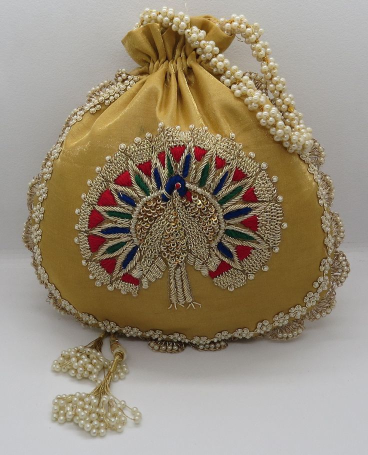 "artisan handmade golden zardosi and thread embroider art deco peacock silk fabric handbag potli bag for woman | indian wedding potli bag Material: Silk Package Contents: As per quantity purchased Size: 10\" x 8\" Designed with the heart, this beautiful Potli or batawa bag are eye catchy and made of premium material. Key Features: Embroidery art work This potli is good match with both Indian and western outfits and are superb for wedding and festive parties This would be best complement to your Cheap Handmade Traditional Shoulder Bag, Bollywood Style Gold Festive Shoulder Bag, Gold Shoulder Bag For Diwali, Bohemian Gold Bags For Festive Occasions, Gold Potli Bag With Handwork For Gift, Festive Gold Shoulder Bag With Dori Work, Gold Shoulder Bag With Dori Work For Gift, Bollywood Style Gold Shoulder Bag With Zari Work, Bohemian Gold Bags For Festivals