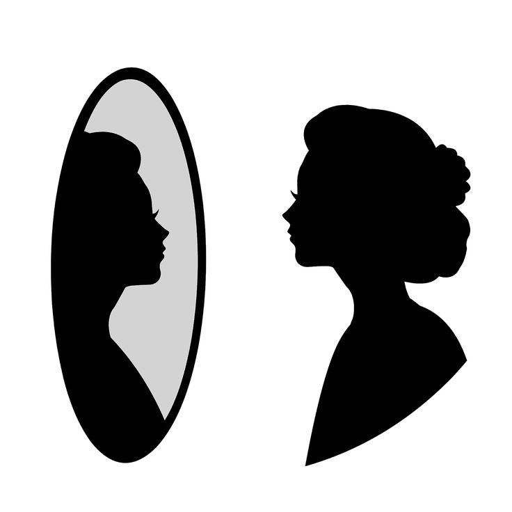 the silhouette of a woman looking at her hair in front of a mirror with an oval shape