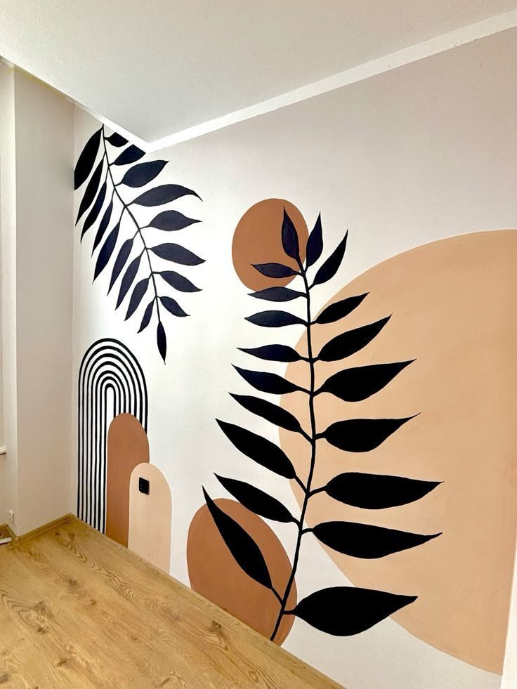 the wall is painted with black and white leaves on it, along with an orange circle