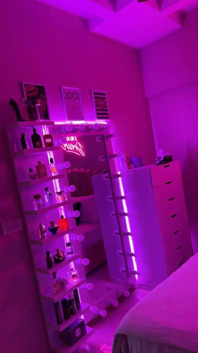 a bed room with a neatly made bed and purple lighting