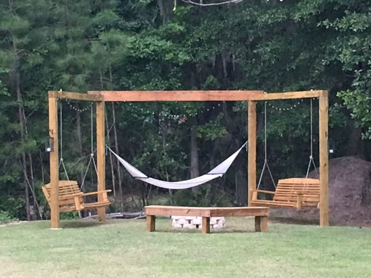 a hammock swing set with two chairs and a bench