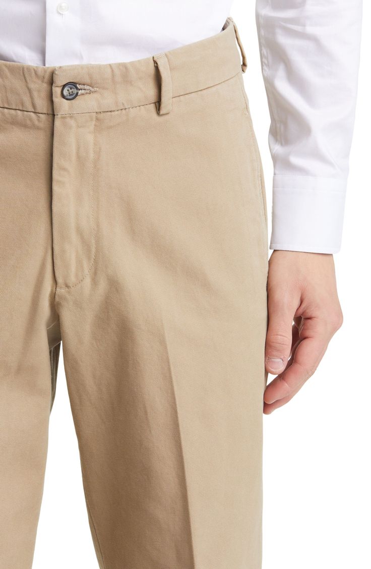 Tailored from soft cotton, these classic flat-front khakis feature a slightly relaxed fit and crisp creases running smartly down the legs. Zip fly with button closure Side-seam pockets; coin pocket 100% cotton Machine wash, tumble dry Imported Relaxed Fit Chinos With Welt Pockets For Business Casual, Elegant Beige Cotton Chinos, Classic Chinos With Pressed Crease For Work, Classic Fitted Beige Chinos, Classic Spring Chinos With Patch Pockets, Classic Tapered Leg Chinos For Work, Classic Relaxed Fit Chinos For Work, Classic Beige Chinos With Welt Pockets, Classic Solid Color Relaxed Fit Chinos