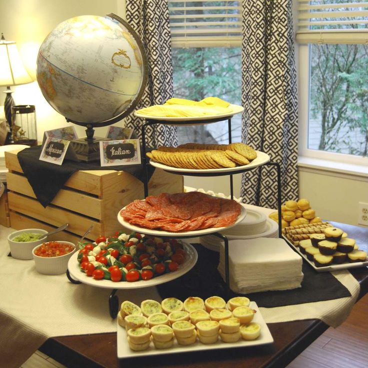 an assortment of desserts and pastries on a table in front of a window