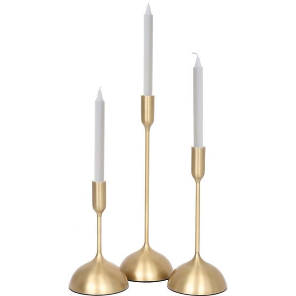 two brass candlesticks with white candles on them