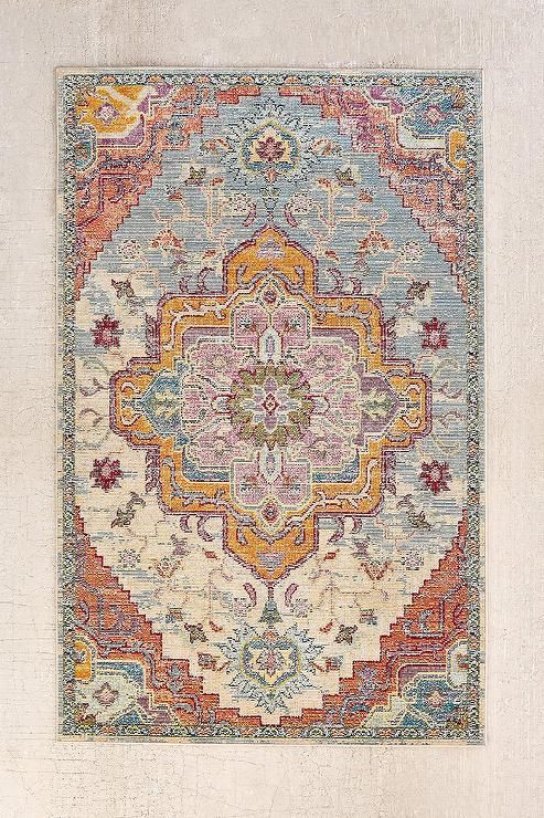 a multicolored area rug with an ornate design on the front and back sides