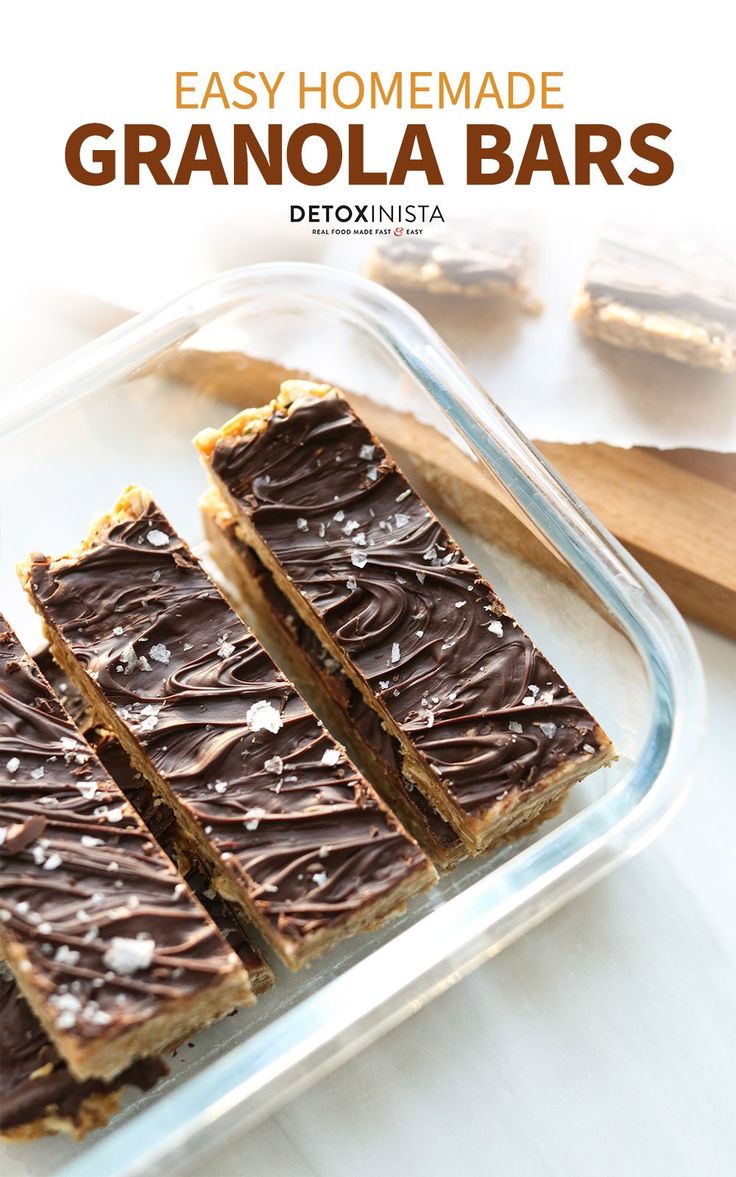 easy homemade granola bars with chocolate frosting in a glass dish on a white table