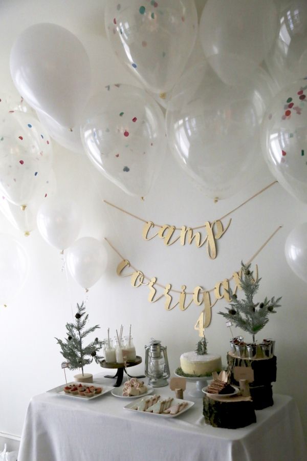 a table topped with lots of white balloons