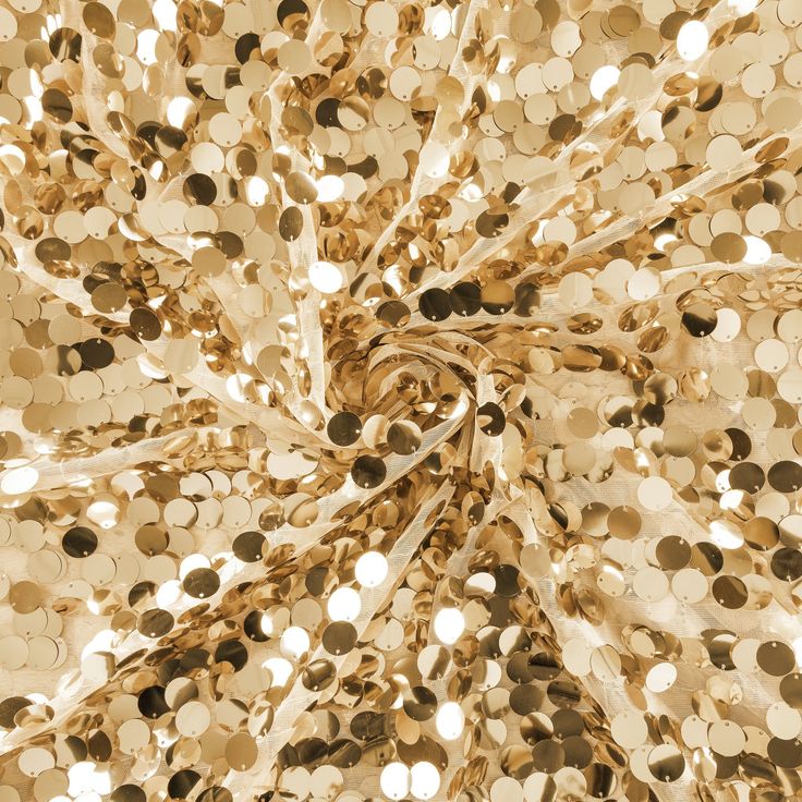 an image of gold sequins that are in the shape of a spiral pattern