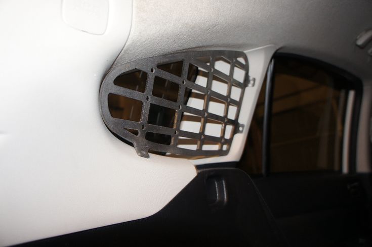 the inside of a car with an air vent on it's side door window