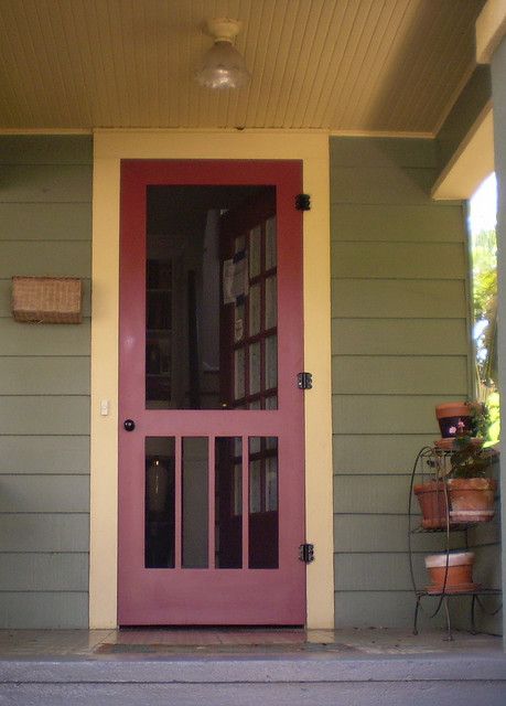 a pink door on the side of a house