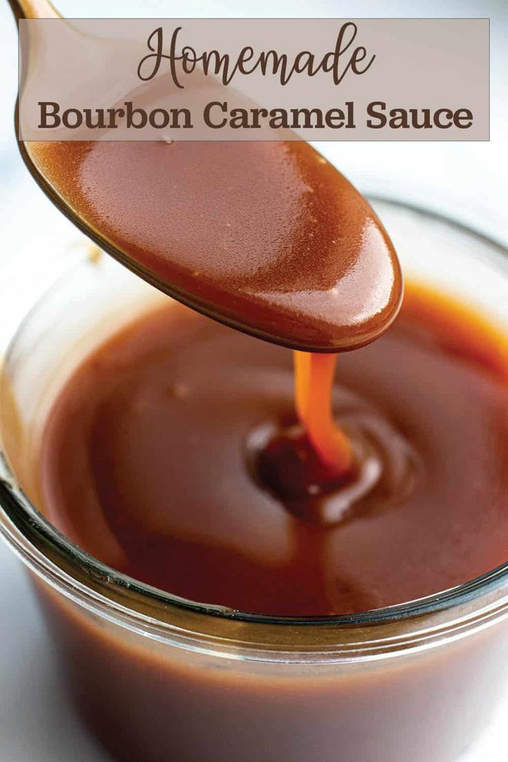 homemade bourbon caramel sauce in a glass jar with a spoon pouring it into the bowl