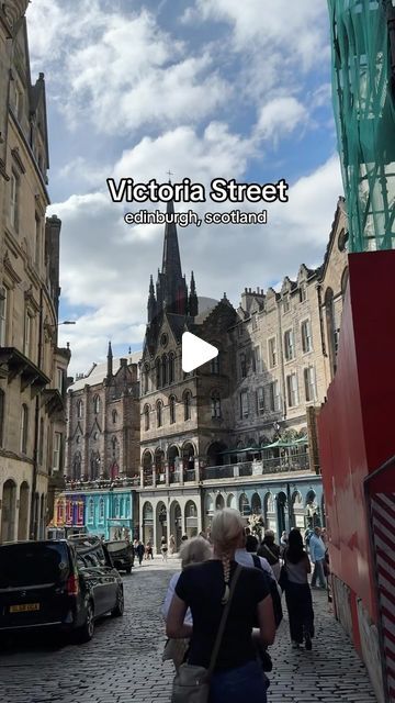 people walking down a cobblestone street in an old european city with the words victoria street edinburgh scotland