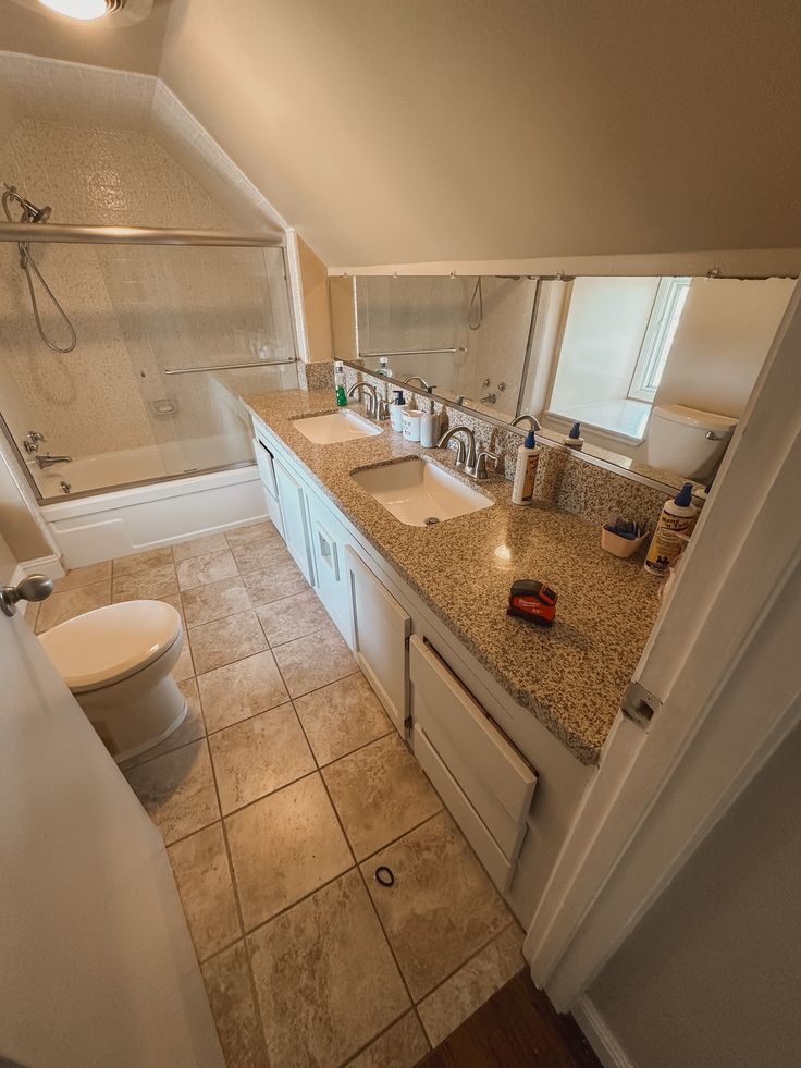 a bathroom with two sinks and a toilet