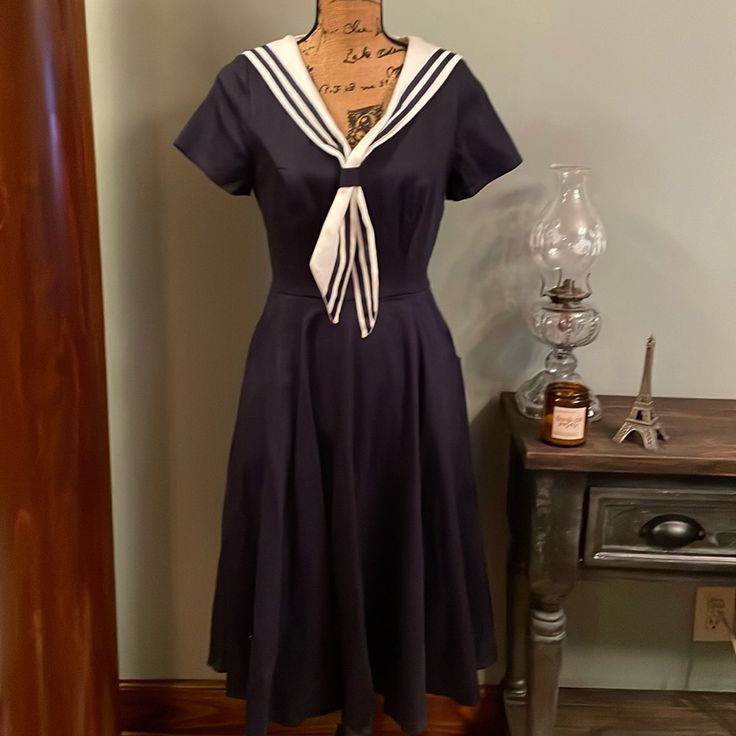 Navy Blue Sailor Collectif Dress. Collar Is Removable, With A Back Zip. Two Hip Deep Pockets. Size Small. Chest 17” Waist 13.5” Hips 26.5” Length 52.5” New With Tag. Purchased In Whitby, England. 98% Cotton 2% Elastane. Machine Wash. Sailor Inspired Outfit, Marine Dress Blues Uniform, Sailor Dress Women, Whitby England, Sailor Blouse, 2024 Wishlist, Vintage Sailor, Dress Collar, Sailor Fashion