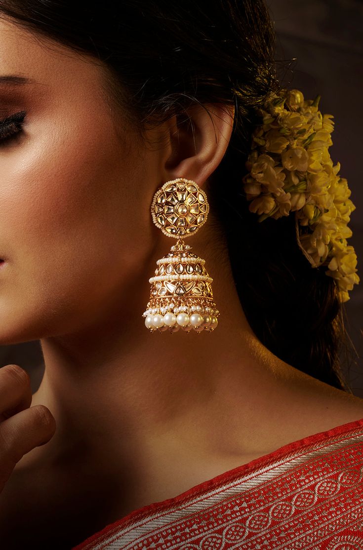 Add a touch of traditional elegance to your ensemble with these dramatic jhumkas in gold, adorned with cascading pearls. Perfect for complementing traditional attire, these earrings exude timeless charm and sophistication. Finish: 22KT Gold Plating Material: Brass, Kundan, Pearls Color: Gold Size: One Size Closure Type: Push Back Box Contains: 1 Pair of Earrings Pearl Jhumkas, Hand Jewelry Rings, Chain Braid, Traditional Attire, Hand Jewelry, Anklet Jewelry, Pearl Color, Charm Gift, Gold Plating