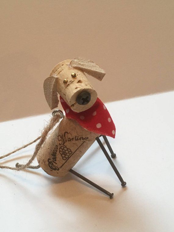 a dog made out of wine cork sitting on top of a white table next to a wall