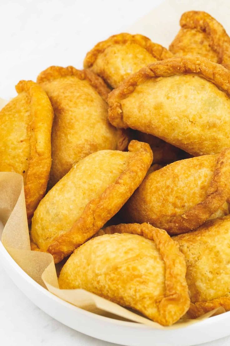 some fried food in a white bowl on a table