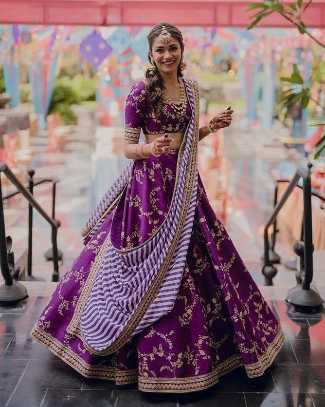 a woman in a purple and white dress