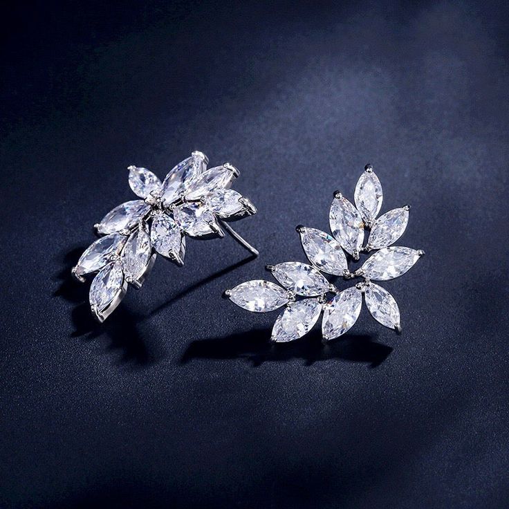 A delightfully unique pair of bridal earrings with an incredible sparkle! Adorned with flawlessly faceted cubic zirconia that capture the light in a dazzling array of sparkles, the earrings are rhodium plated for a bright finish which enhances the intricate detailing and conveys a modern take on old elegance. The earrings are 1" (approx. 2.5cm) in length and come with sturdy backs. Available in Silver, Rose Gold and Yellow Gold finishes. To make your choice select your preferred finish from the Dazzling Diamond White Crystal Earrings, Sparkling Dazzling Crystal Earrings, Cubic Zirconia Sparkling Stones Drop Earrings, Sparkling Cubic Zirconia Crystal Earrings, Elegant Sparkling Crystal Cluster Earrings, Diamond White Cubic Zirconia Bridal Earrings For Party, Dazzling Cubic Zirconia Bridal Earrings, Dazzling Cubic Zirconia Bridal Earrings For Evening, Diamond White Sparkling Earrings