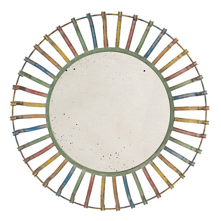 a circular mirror with multicolored sticks in the center on a white background,