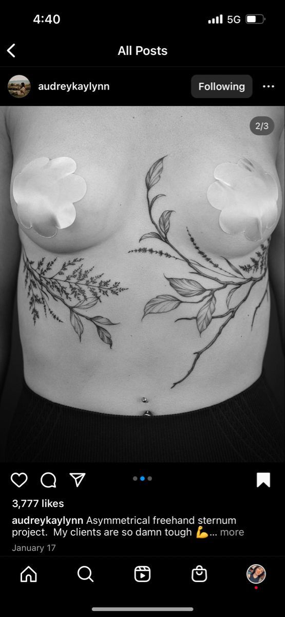 a black and white photo of a woman's breast with flowers on it,